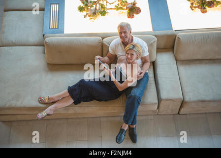 High angle view of Caucasian couple using digital tablet in hotel lobby Stock Photo