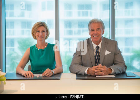 Caucasian business people smiling in meeting