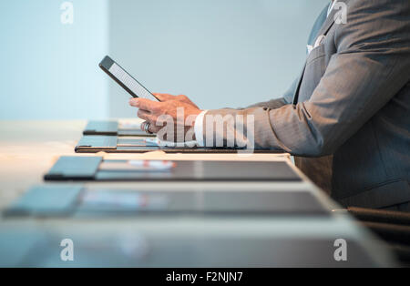 Caucasian businessman using digital tablet at conference table Stock Photo