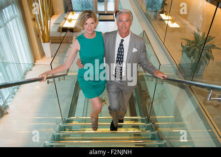 Caucasian couple walking up office stairs Stock Photo