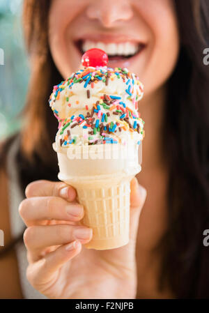 Close up of woman holding ice cream cone