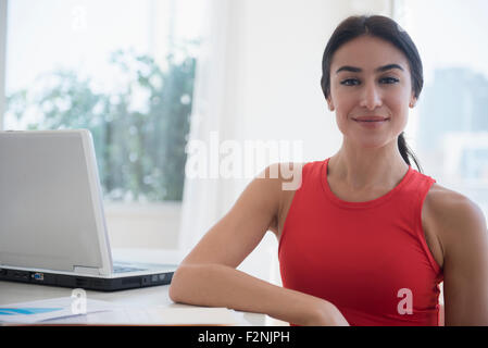Businesswoman sitting at laptop at desk Stock Photo