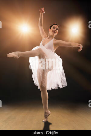 Hispanic ballet dancer performing on stage Stock Photo