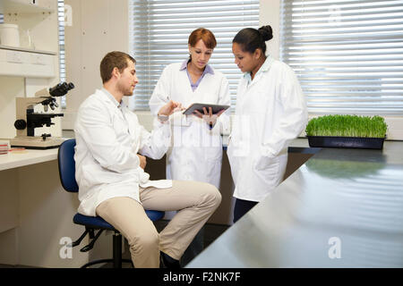 Scientists using digital tablet in laboratory Stock Photo