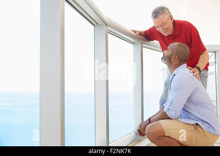 Father and son standing on balcony Stock Photo