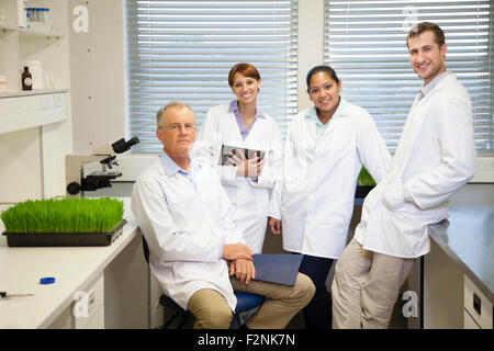 Scientists posing in laboratory Stock Photo