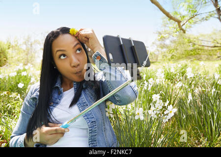 Black woman taking self portrait in park Stock Photo