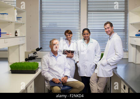 Scientists smiling in laboratory Stock Photo
