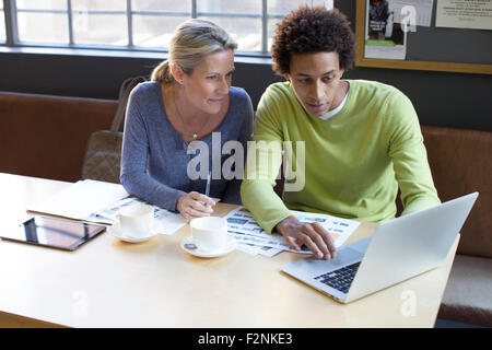 Business people using laptop in office meeting Stock Photo
