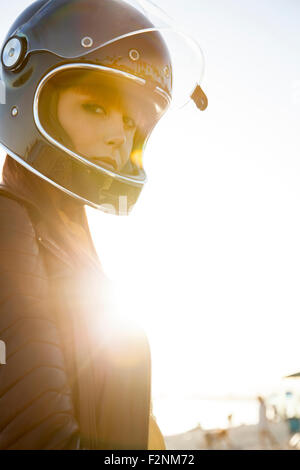 Caucasian woman wearing motorcycle helmet Stock Photo