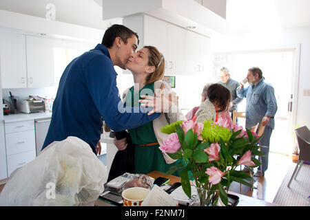 Couple kissing in kitchen Stock Photo