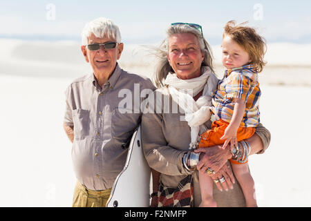 Caucasian grandparents and grandson smiling in desert Stock Photo