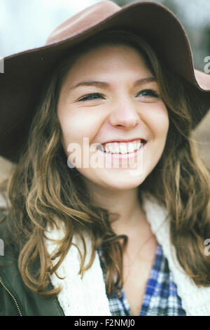 Smiling Caucasian woman wearing sun hat Stock Photo