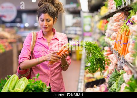 Hispanic woman shopping at grocery store Stock Photo