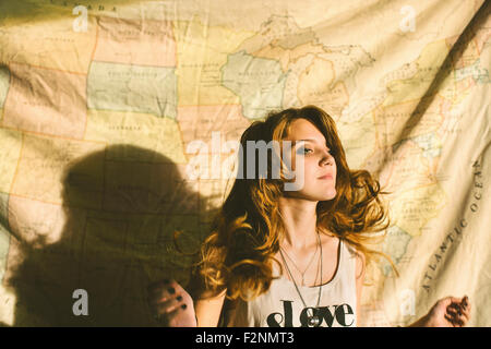 Caucasian woman standing in front of fabric map Stock Photo