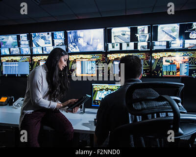 Security guards watching monitors in control room Stock Photo