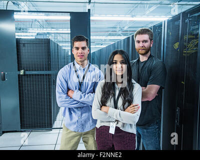 Technicians smiling in server room Stock Photo