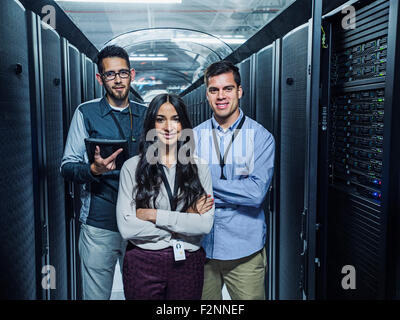 Technicians smiling in server room Stock Photo