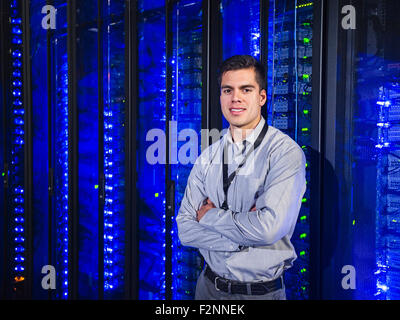 Hispanic technician smiling in server room Stock Photo