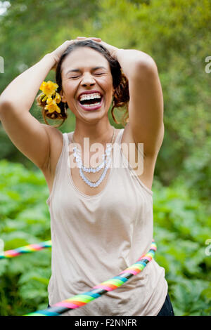 Mixed race woman playing with plastic hoop