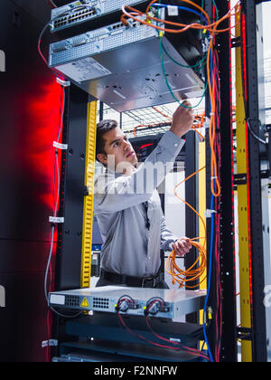 Hispanic technician working in server room Stock Photo