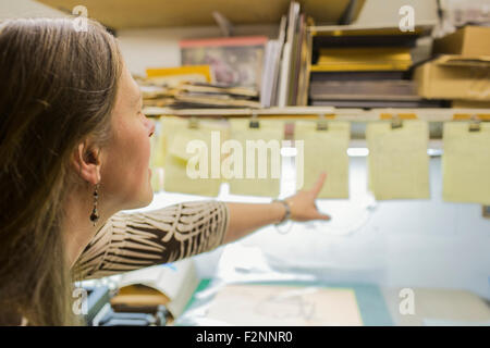 Caucasian artist working in workshop Stock Photo