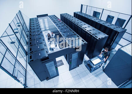 High angle view of technicians working in server room Stock Photo