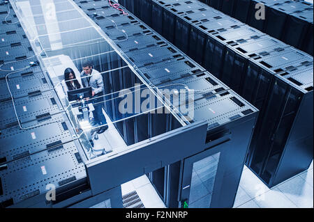 High angle view of technicians working in server room Stock Photo
