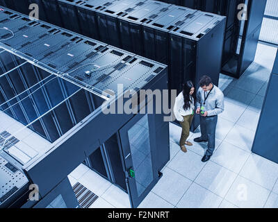 High angle view of technicians talking in server room Stock Photo