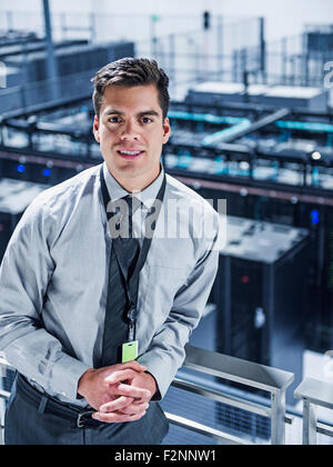 Hispanic businessman standing on balcony over server room Stock Photo