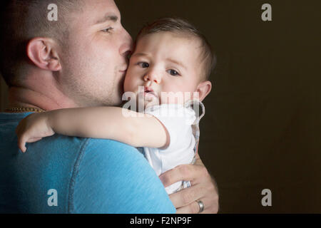 Caucasian father kissing son Stock Photo