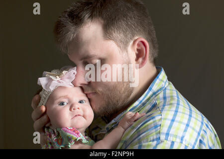 Caucasian father holding daughter