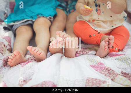 Close up of feet of siblings on blanket Stock Photo