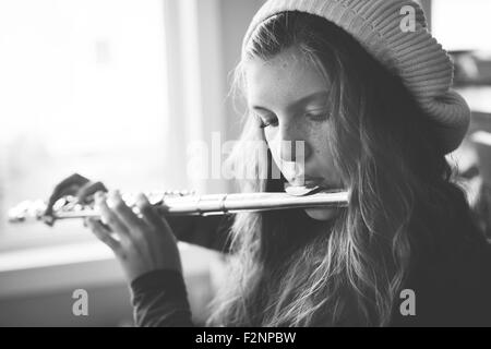 Close up of Caucasian girl playing flute Stock Photo