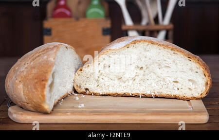 Close up view of an open large loaf of bread in a rustic kitchen Stock Photo