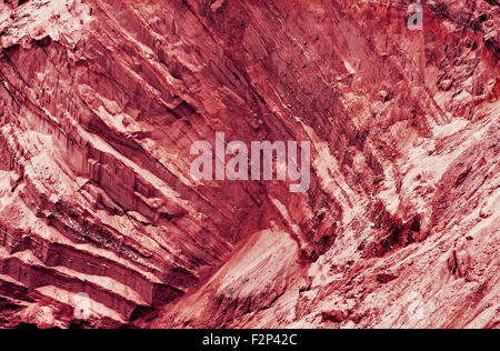 Red fantastic slope with layered texture as abstract background.Toned image. Stock Photo