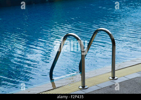 Grab bars ladder in  swimming pool Stock Photo