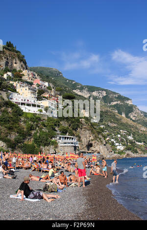 POSITANO, ITALY - JUNE 27, 2015: People enjoying the Mediterranean beach in Positano on the Amalfi Coast of Italy Stock Photo