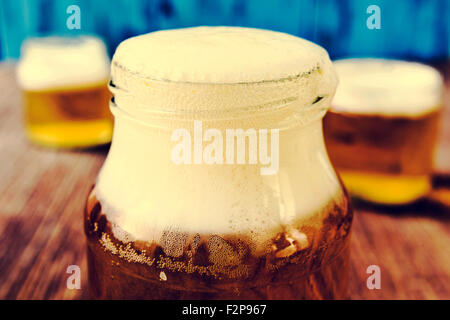 https://l450v.alamy.com/450v/f2p967/refreshing-beer-served-in-glass-jars-on-a-rustic-wooden-table-f2p967.jpg