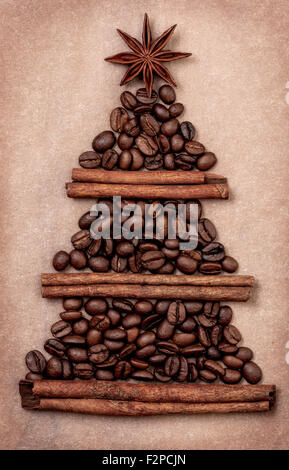 Christmas tree made of cinnamon sticks and coffee beans, star anise on a paper background Stock Photo