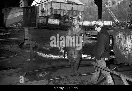 Miners emerging in the cage after completing a shift on the coal face underground in a south Wales colliery, 1982. Stock Photo