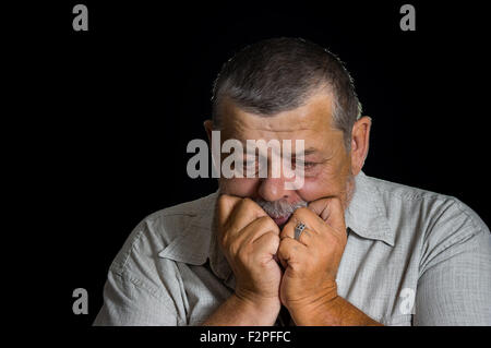Portrait of senior man desperately thinking about life problems Stock Photo