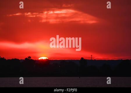 Sunset through red sky Stock Photo