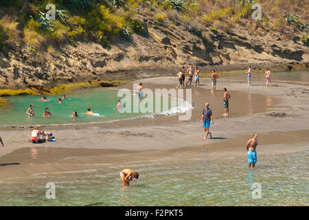 People bathing and relaxing in small beach inside the islet of Vila Franca do Campo off the coast of Sao Miguel island, Azores Stock Photo