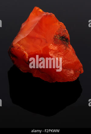 Rough red carnelian rock isolated on black background Stock Photo