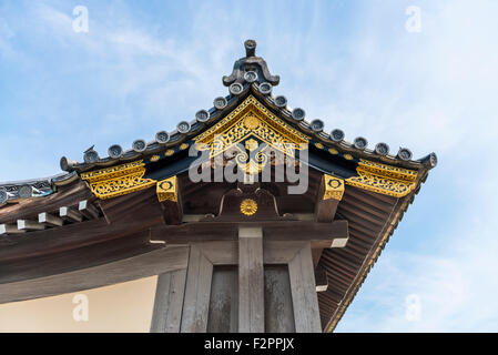 Traditional Japanese ornate wooden roof overhang with gold decoration Stock Photo