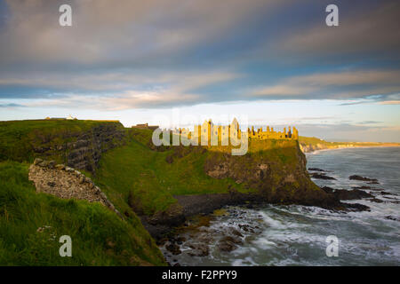 Sunrise over Dunluce Castle along northern coast of County Antrim, Northern Ireland, UK Stock Photo