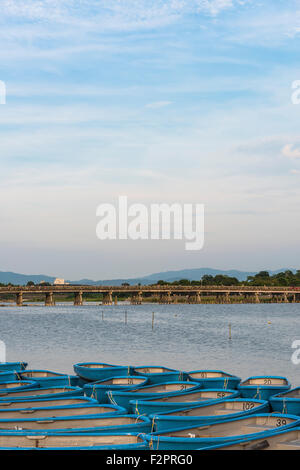 The Togetsukyo Bridge across the Katsura River in Arashiyama with rowing boats moored in the foreground Stock Photo