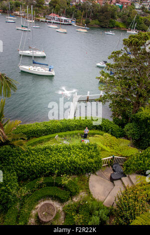 A view from above of a flying drone with a gimbal and camera attached. Stock Photo