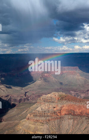 Virga from a summer rain shower creates a rainbow over the Grand Canyon. Stock Photo